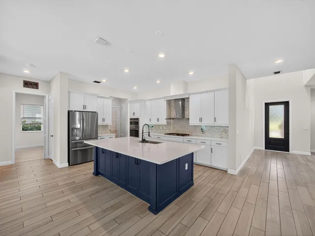 a view of an entryway with wooden floor and door
