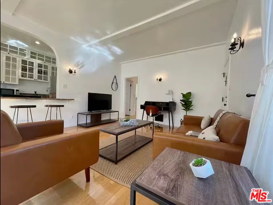 854 4th Street, Unit C Santa Monica, CA 90403 - Photo 2 of 12 a living room with furniture and a flat screen tv