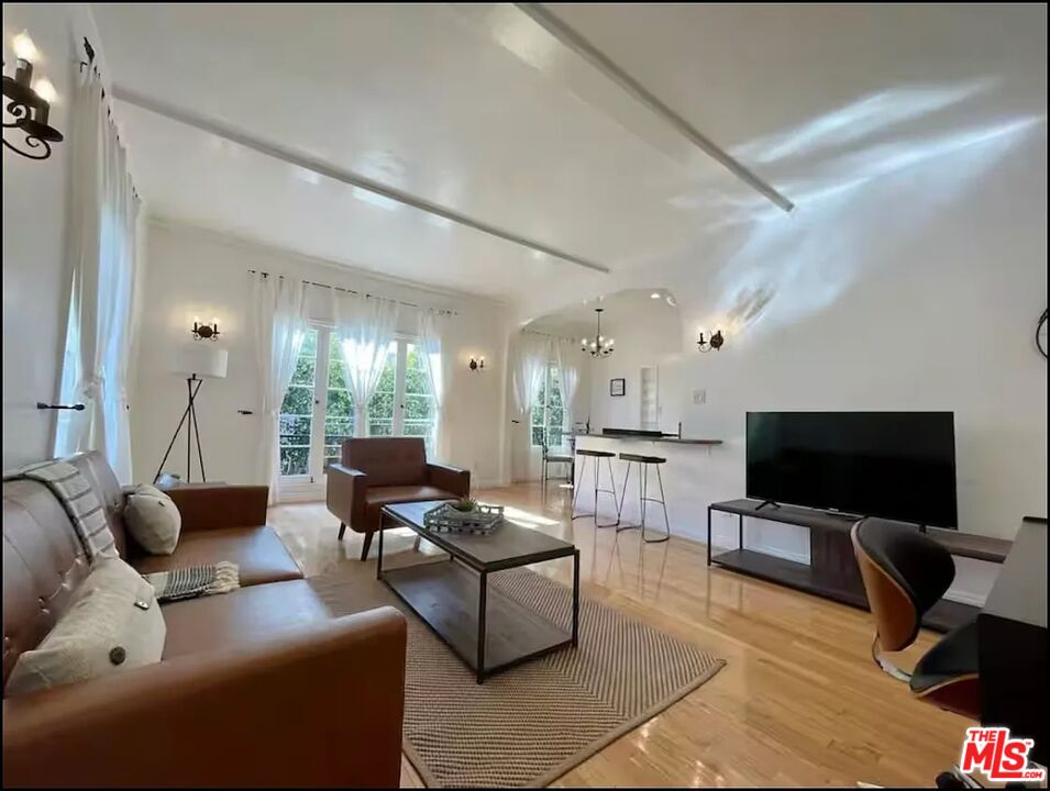 854 4th Street, Unit C Santa Monica, CA 90403 - Photo 3 of 12 a living room with furniture and a flat screen tv