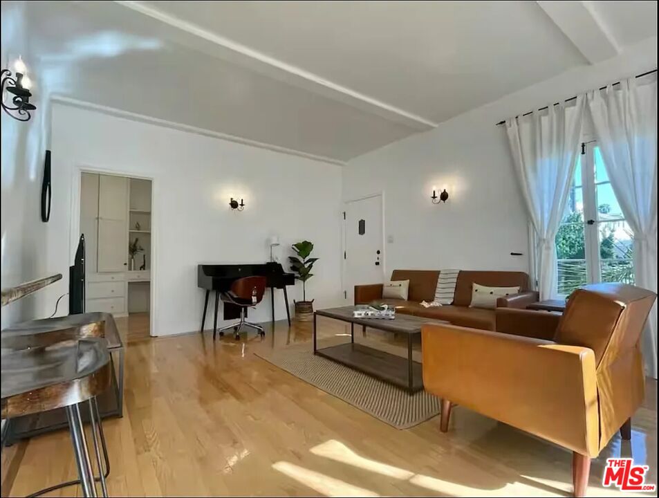 854 4th Street, Unit C Santa Monica, CA 90403 - Photo 4 of 12 a work room with furniture and a window