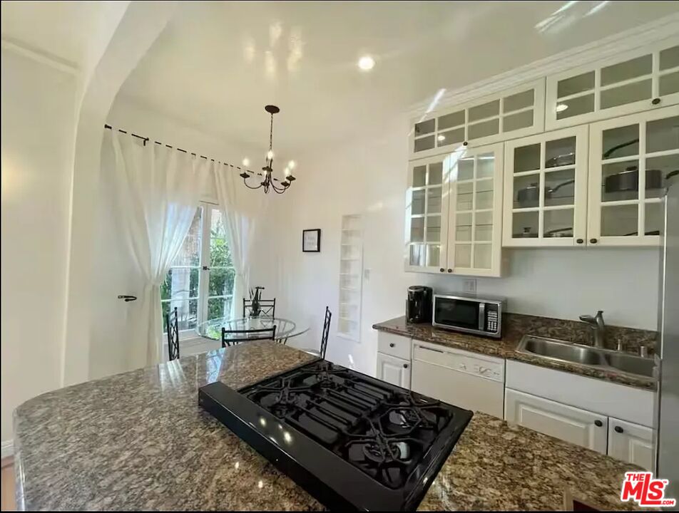 854 4th Street, Unit C Santa Monica, CA 90403 - Photo 6 of 12 a kitchen with a stove and a white cabinet