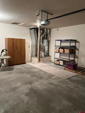 a view of a big room with closet cabinet and a chandelier