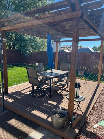 a view of a patio with a table chairs and a floor to ceiling window