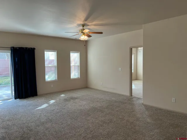 an empty room with windows and closet