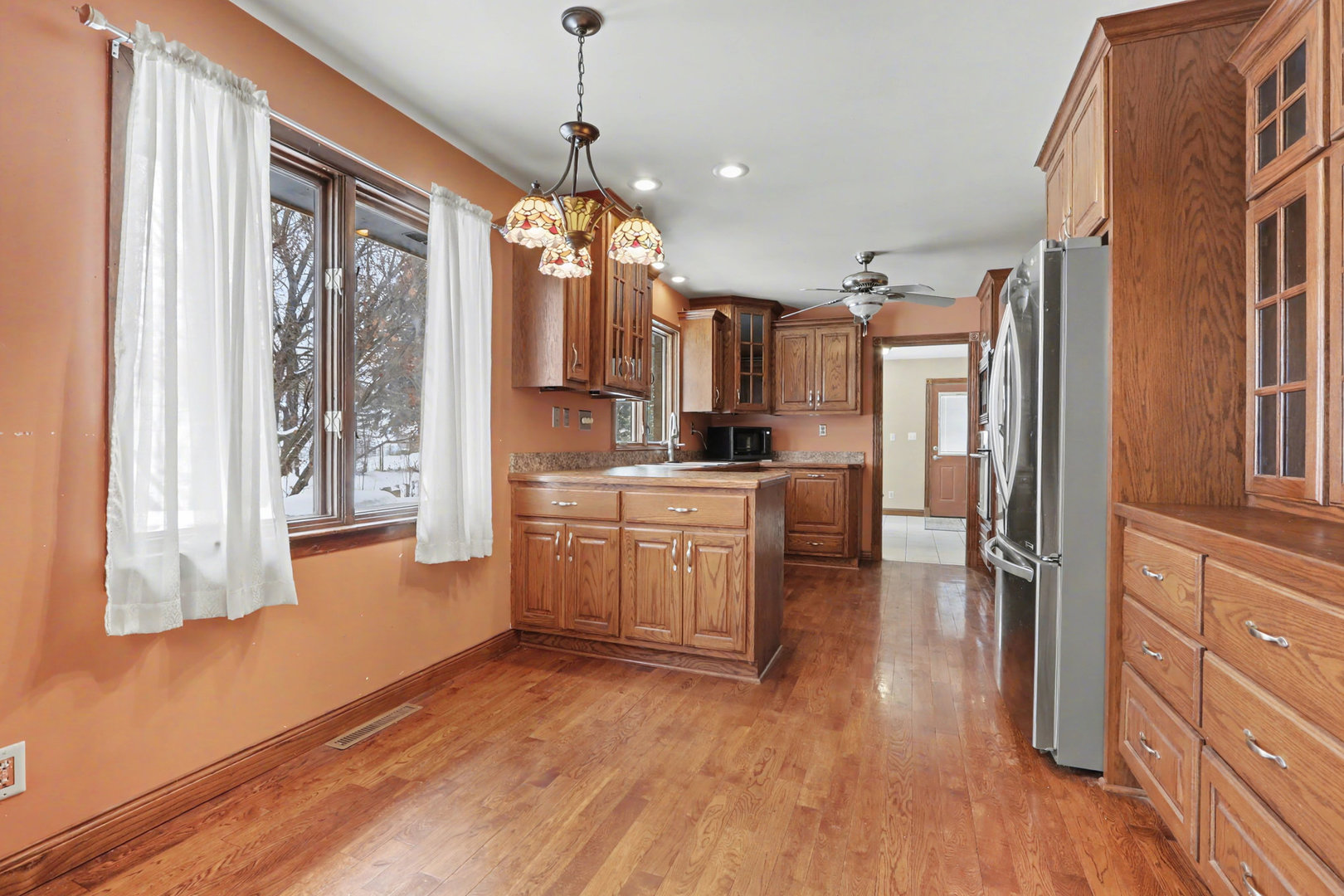 24304 South Frontage Road West Channahon, IL 60410 - Photo 9 of 26 a kitchen with stainless steel appliances kitchen island granite countertop a refrigerator a oven a stove and a wooden floors
