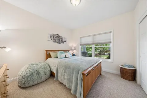 a spacious bedroom with a bed and a table