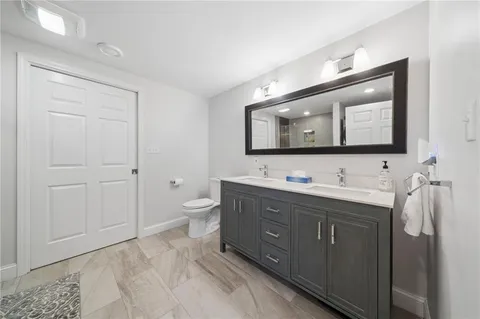 a bathroom with a double vanity sink and mirror