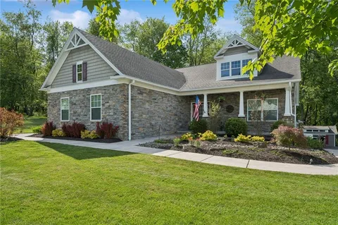 a view of a house with a yard and sitting area