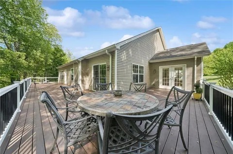 a view of backyard of house with seating space