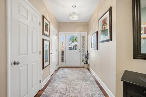 a view of a hallway with windows and entryway