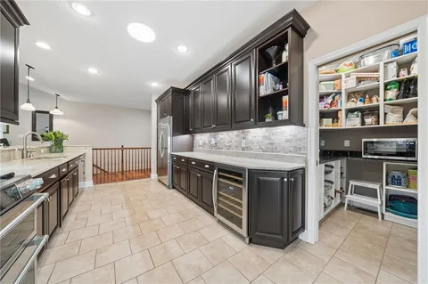a kitchen with stainless steel appliances granite countertop a stove and cabinets