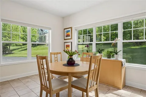 a dining room with furniture window and outside view
