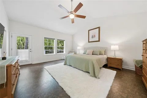 a spacious bedroom with a bed and a large window