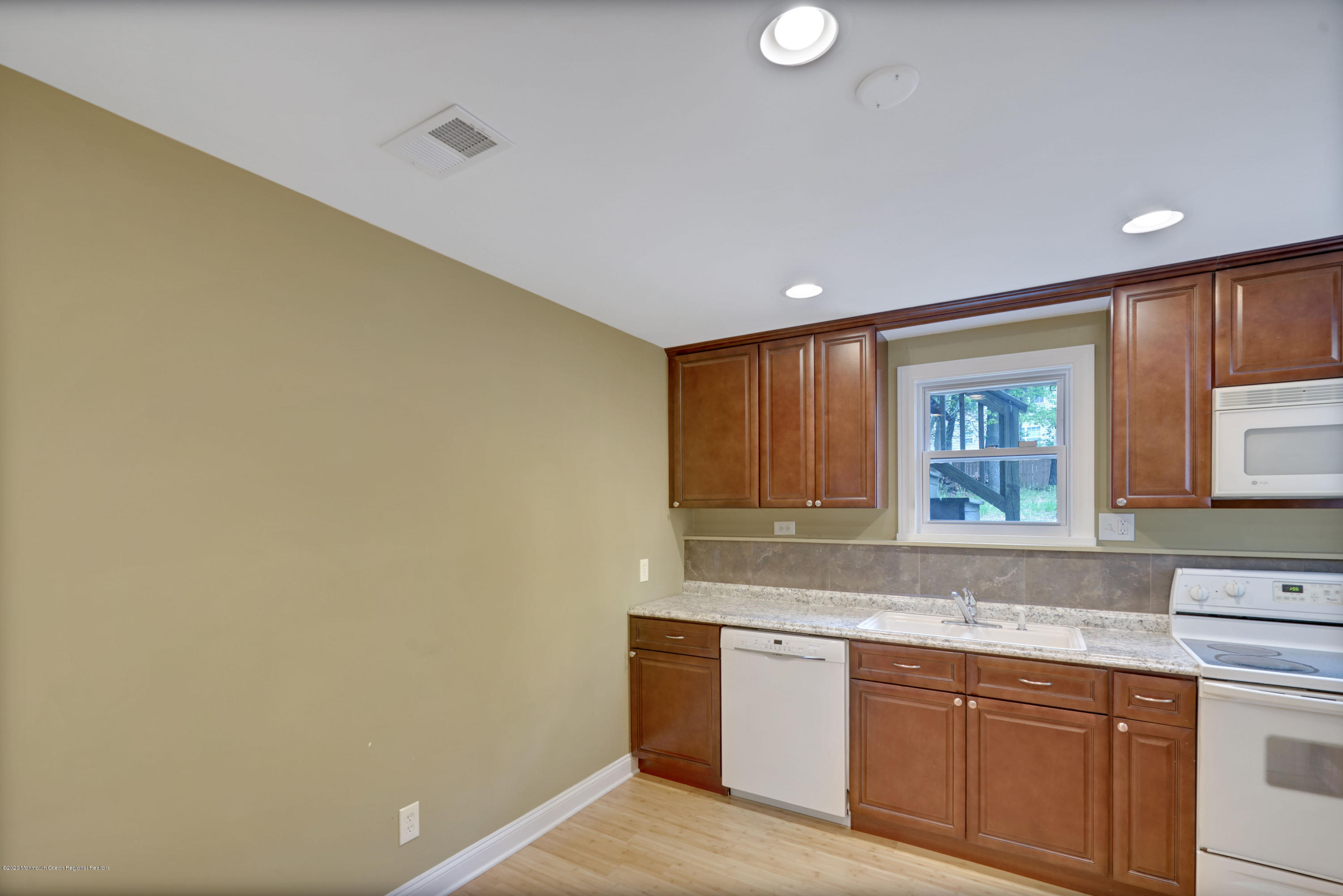 59 Pinewood Road Howell, NJ 07731 - Photo 18 of 31 a kitchen with granite countertop cabinets stainless steel appliances a sink and a window