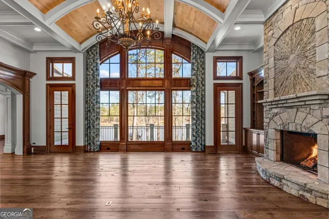 a view of a hallway with wooden floor and a fireplace