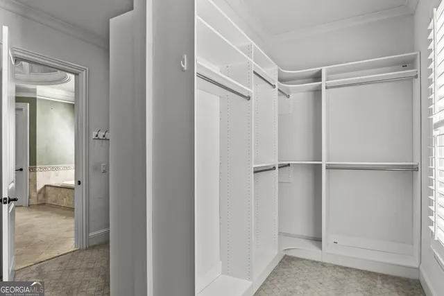 a spacious bathroom with a double vanity sink a mirror and a shower