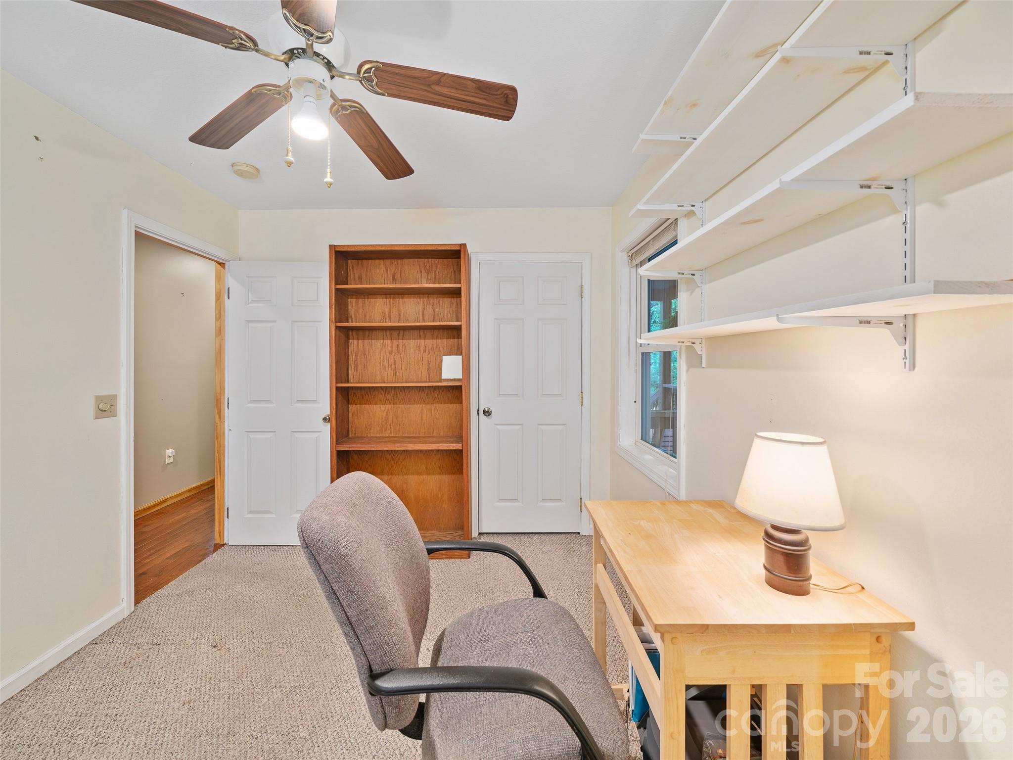 142 Wildflower Road Spruce Pine, NC 28777 - Photo 18 of 46 a bedroom with furniture and a chandelier
