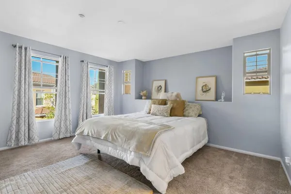 a bedroom with a large bed and a window