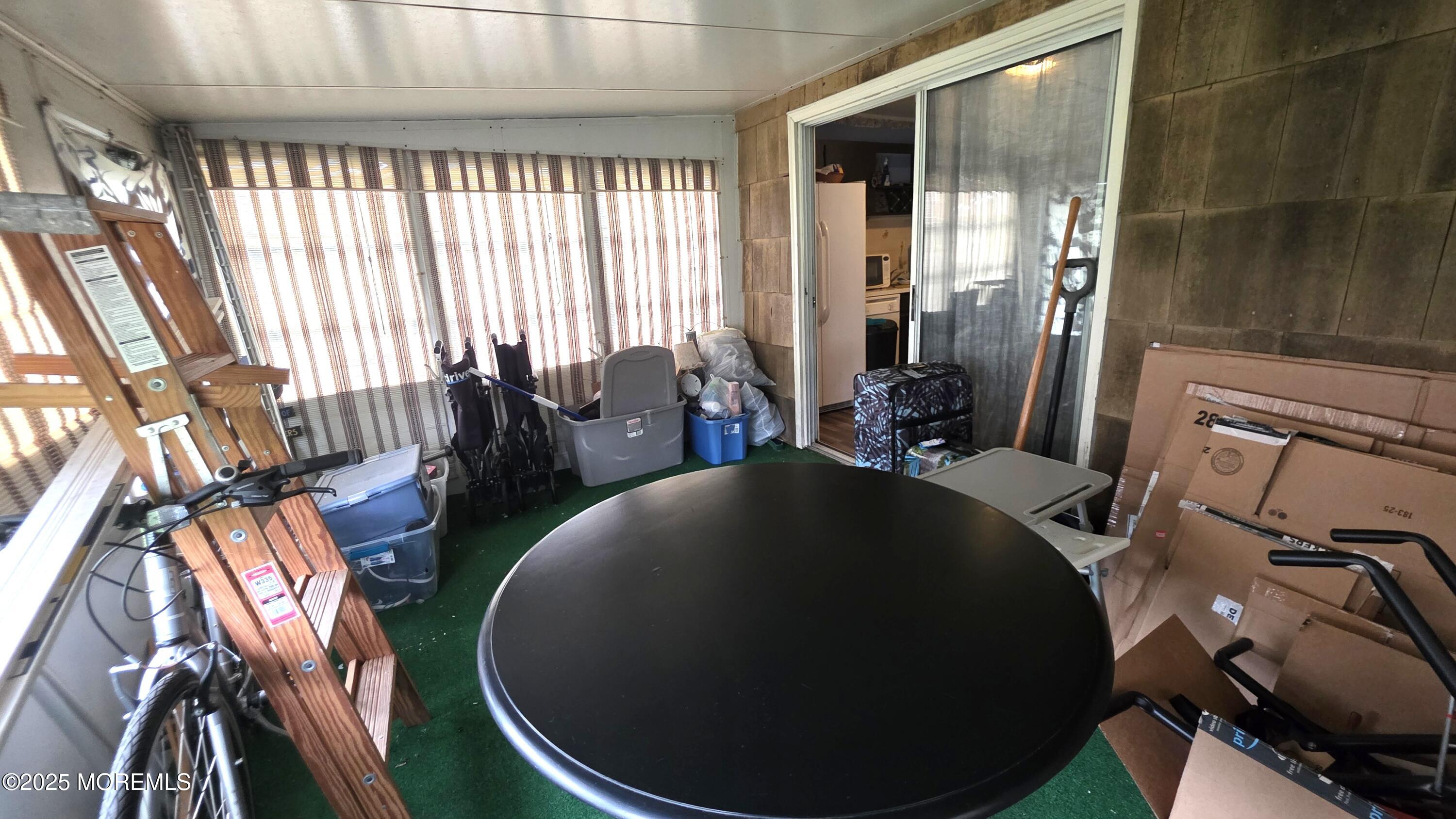 66 Breeze Court, Unit 97 Brick, NJ 08724 - Photo 15 of 18 a living room with furniture and a floor to ceiling window