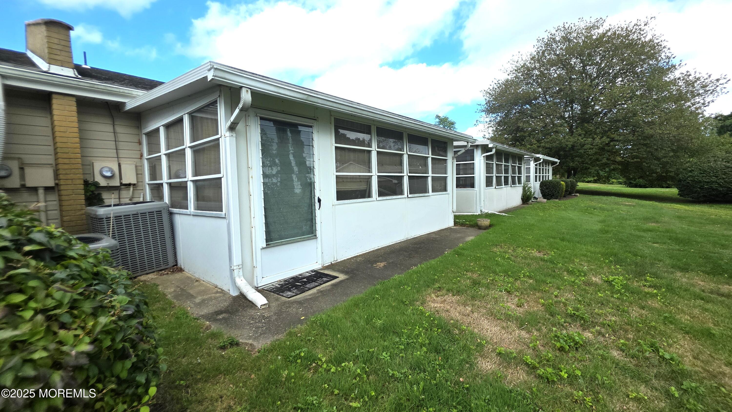 66 Breeze Court, Unit 97 Brick, NJ 08724 - Photo 16 of 18 a view of backyard with deck and garden