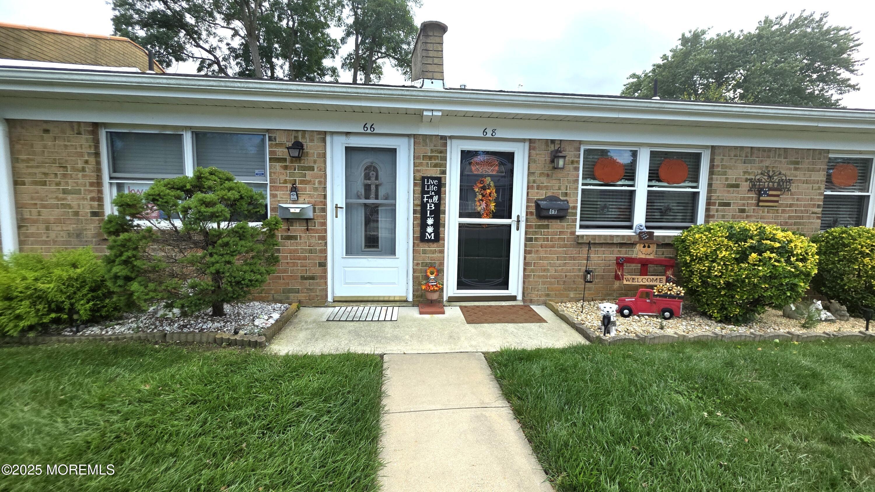 66 Breeze Court, Unit 97 Brick, NJ 08724 - Photo 3 of 18 front view of a house with a yard