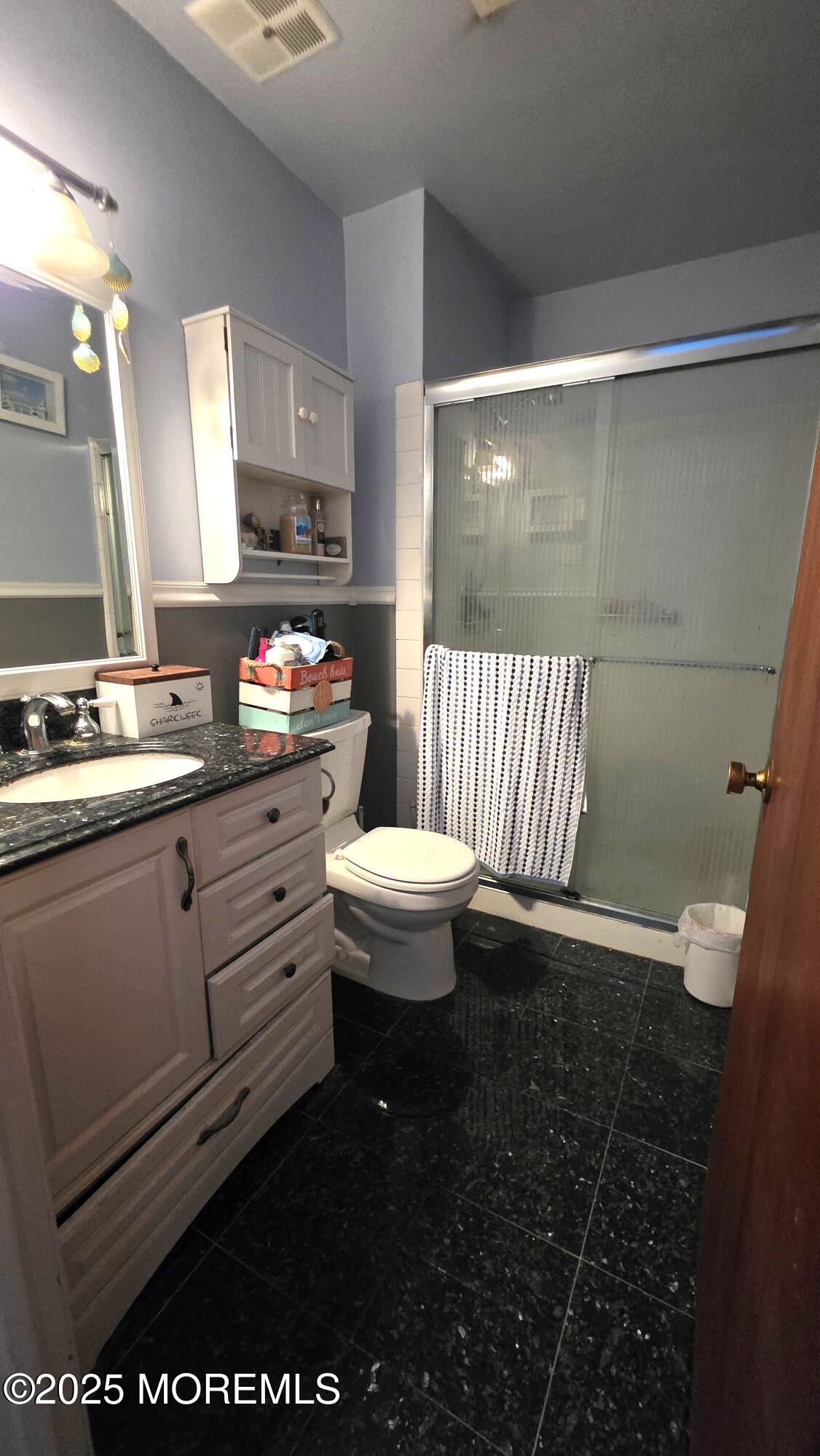 66 Breeze Court, Unit 97 Brick, NJ 08724 - Photo 10 of 18 a bathroom with a sink a toilet and mirror