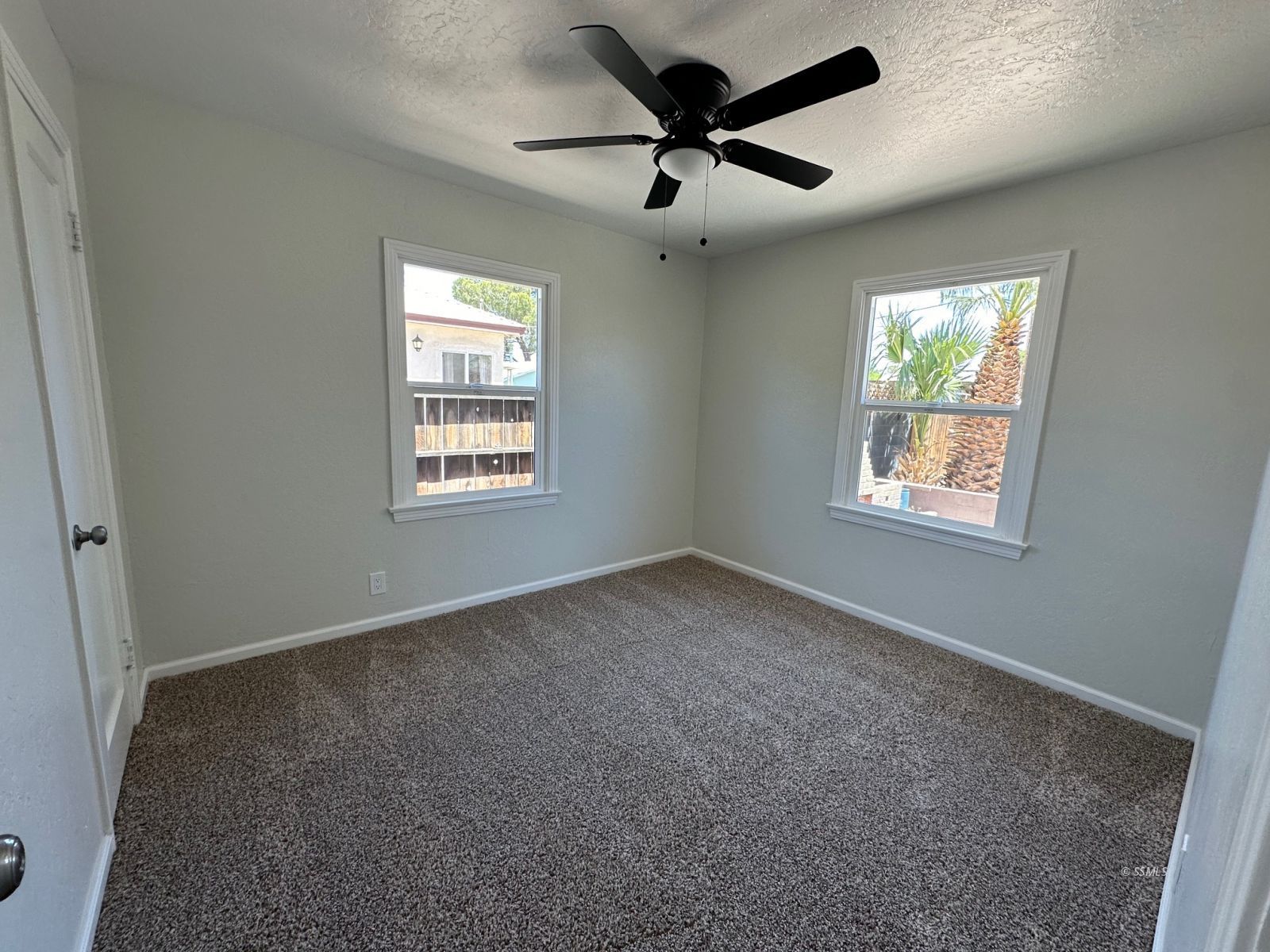300 North Sanders Street Ridgecrest, CA 93555 - Photo 11 of 15 an empty room with a window and a fan