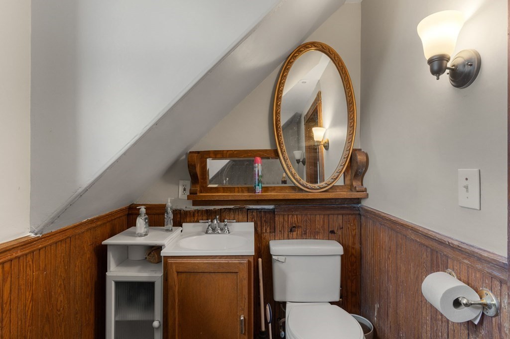 10-12 Castlerock Street, Unit 2 Boston, MA 02125 - Photo 16 of 24 a bathroom with a toilet a sink and a mirror