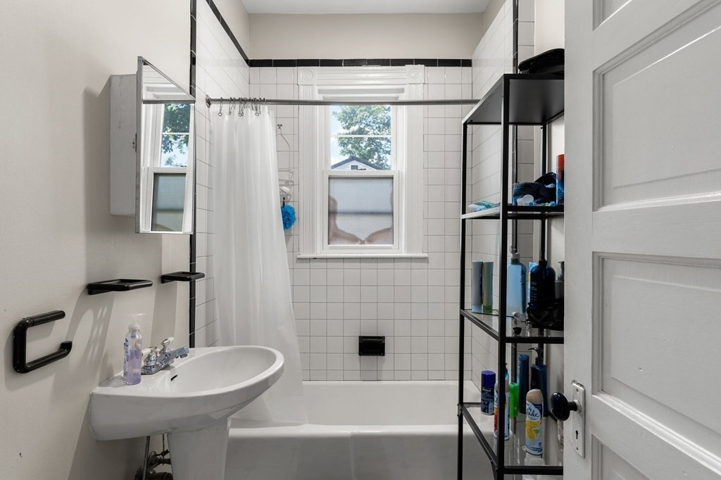 10-12 Castlerock Street, Unit 2 Boston, MA 02125 - Photo 10 of 24 a bathroom with a sink a bathtub and a mirror