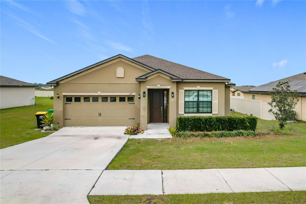 1376 Swan Lake Circle Dundee, FL 33838 - Photo 1 of 1 a front view of a house with a yard and garage