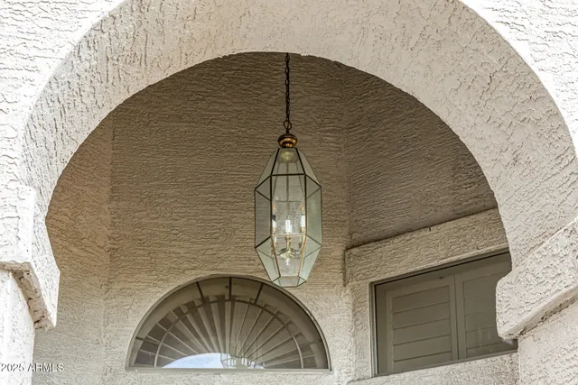 a living room with a couch and a potted plant