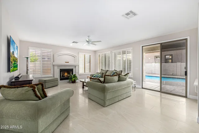 a kitchen with stainless steel appliances granite countertop white cabinets a dining table and chairs