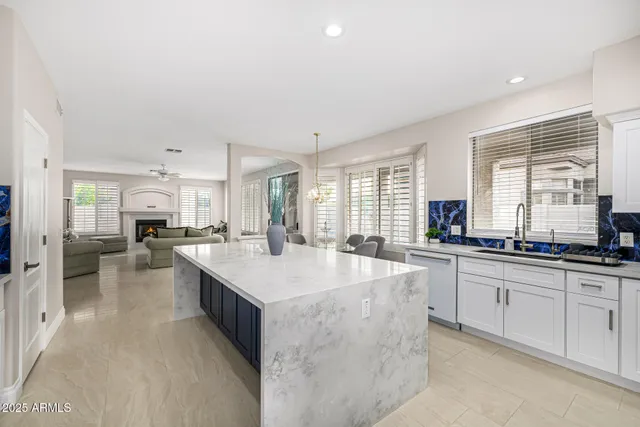 an empty room with wooden floor and ceiling fan