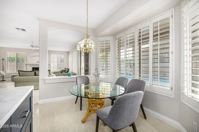 a bathroom with a sink a toilet and a large mirror