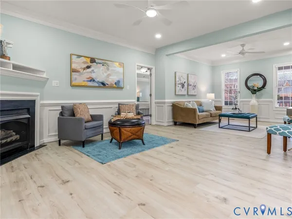 a large kitchen with stainless steel appliances granite countertop a stove a refrigerator a sink a dining table and chairs with the wooden floor