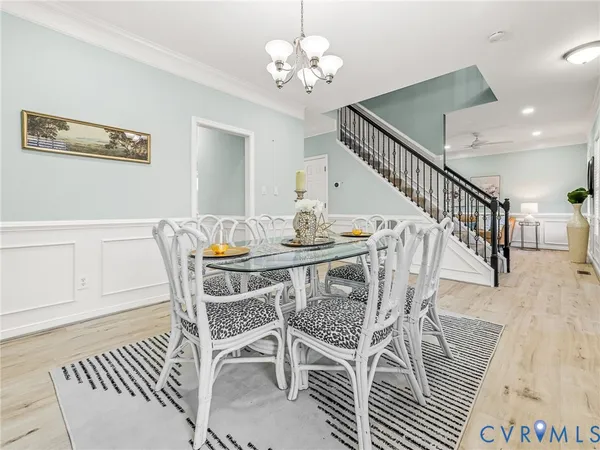 a living room with furniture a fireplace and a chandelier