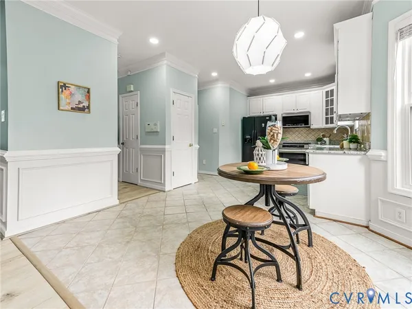 a bedroom with a large bed chandelier and a window