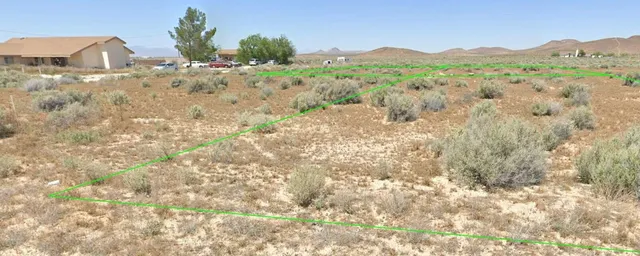a view of a dry yard with mountain
