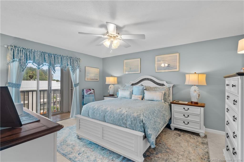 1864 Southwest Palm City Road, Unit 303 Stuart, FL 34994 - Photo 14 of 26 a bedroom with a large bed and a window