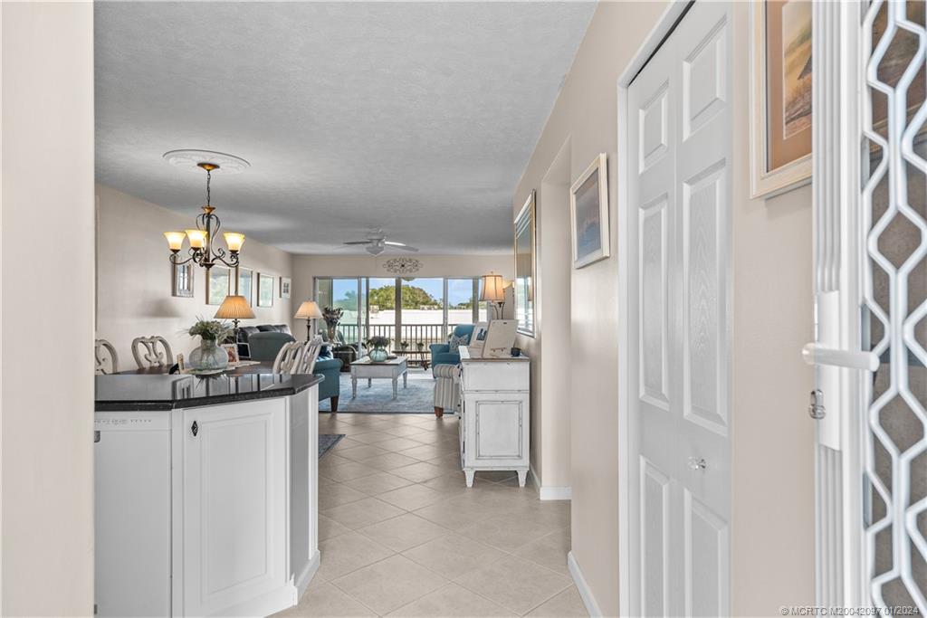 1864 Southwest Palm City Road, Unit 303 Stuart, FL 34994 - Photo 6 of 26 a kitchen view with stainless steel appliances kitchen island granite countertop a refrigerator and a sink