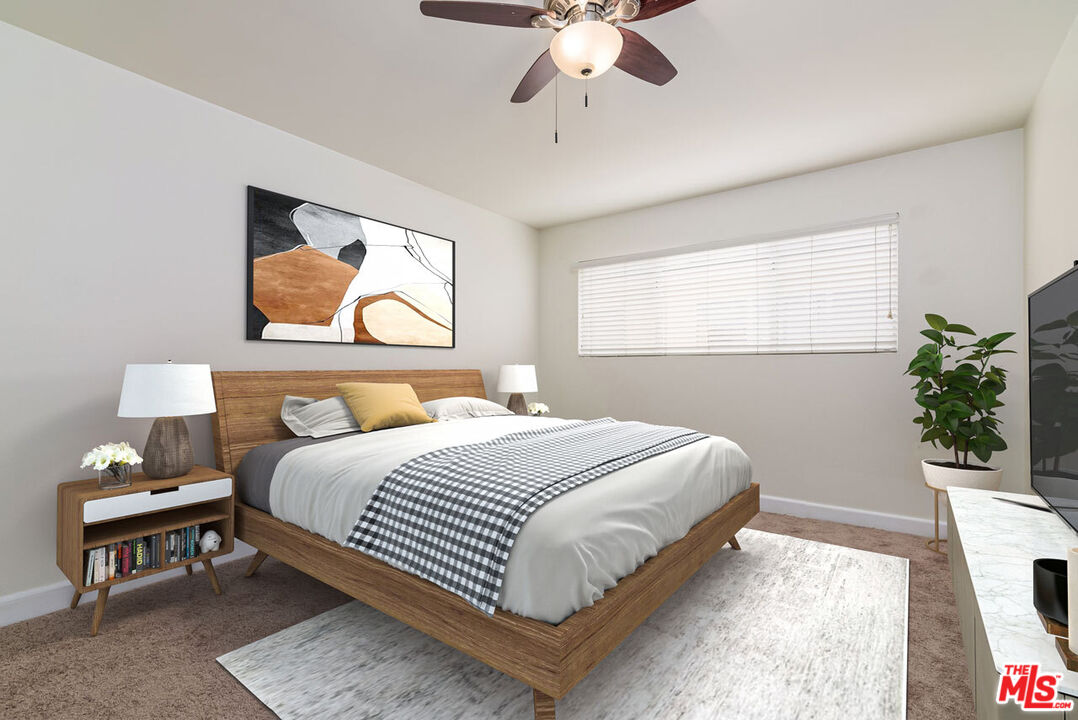 1920 North H Street, Unit 246 Oxnard, CA 93036 - Photo 14 of 31 a bedroom with a bed and a chandelier