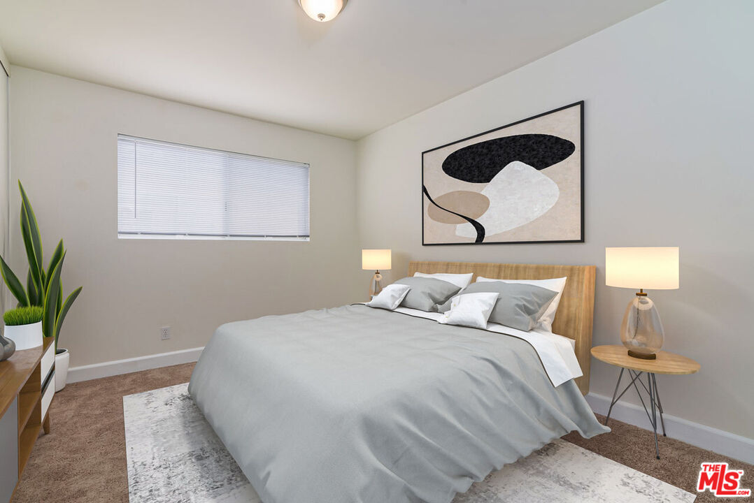 1920 North H Street, Unit 246 Oxnard, CA 93036 - Photo 16 of 31 a bedroom with a bed and a potted plant