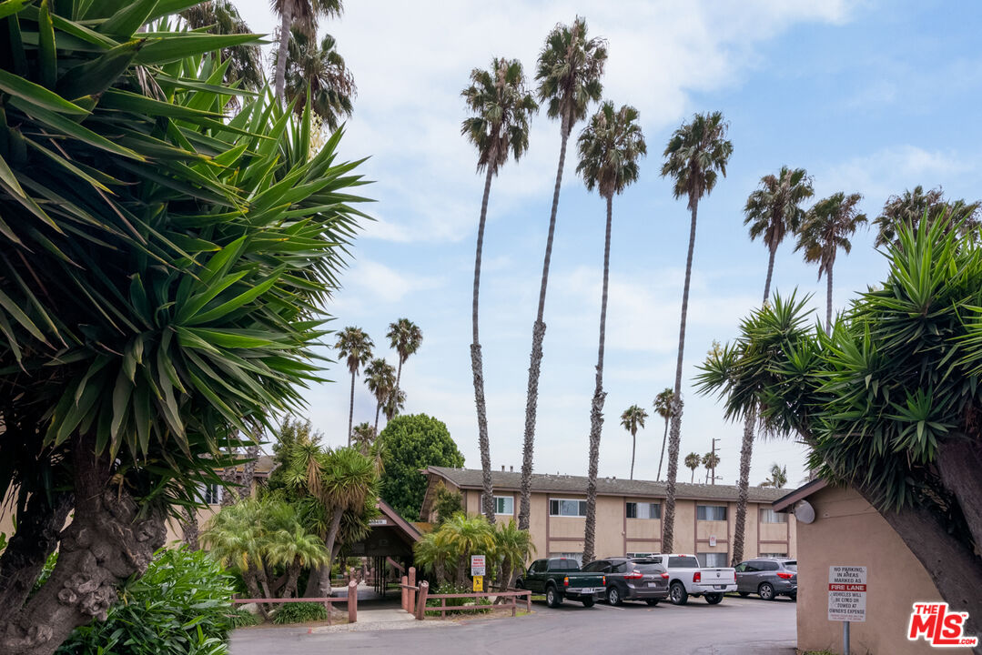 1920 North H Street, Unit 246 Oxnard, CA 93036 - Photo 30 of 31 a view of a city street lined with buildings and palm trees