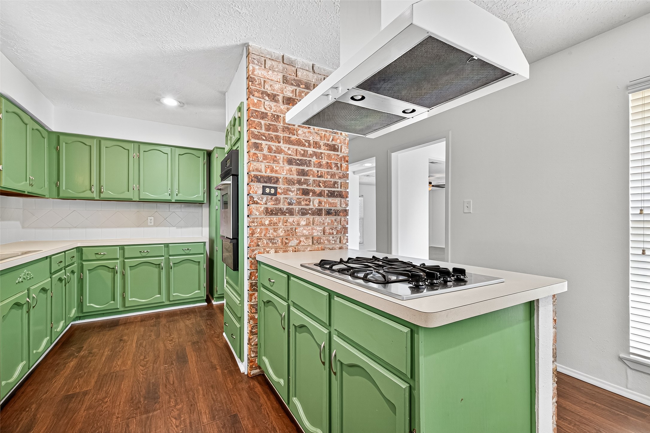 12910 Aste Lane Houston, TX 77065 - Photo 16 of 37 a kitchen with cabinets a stove and a microwave