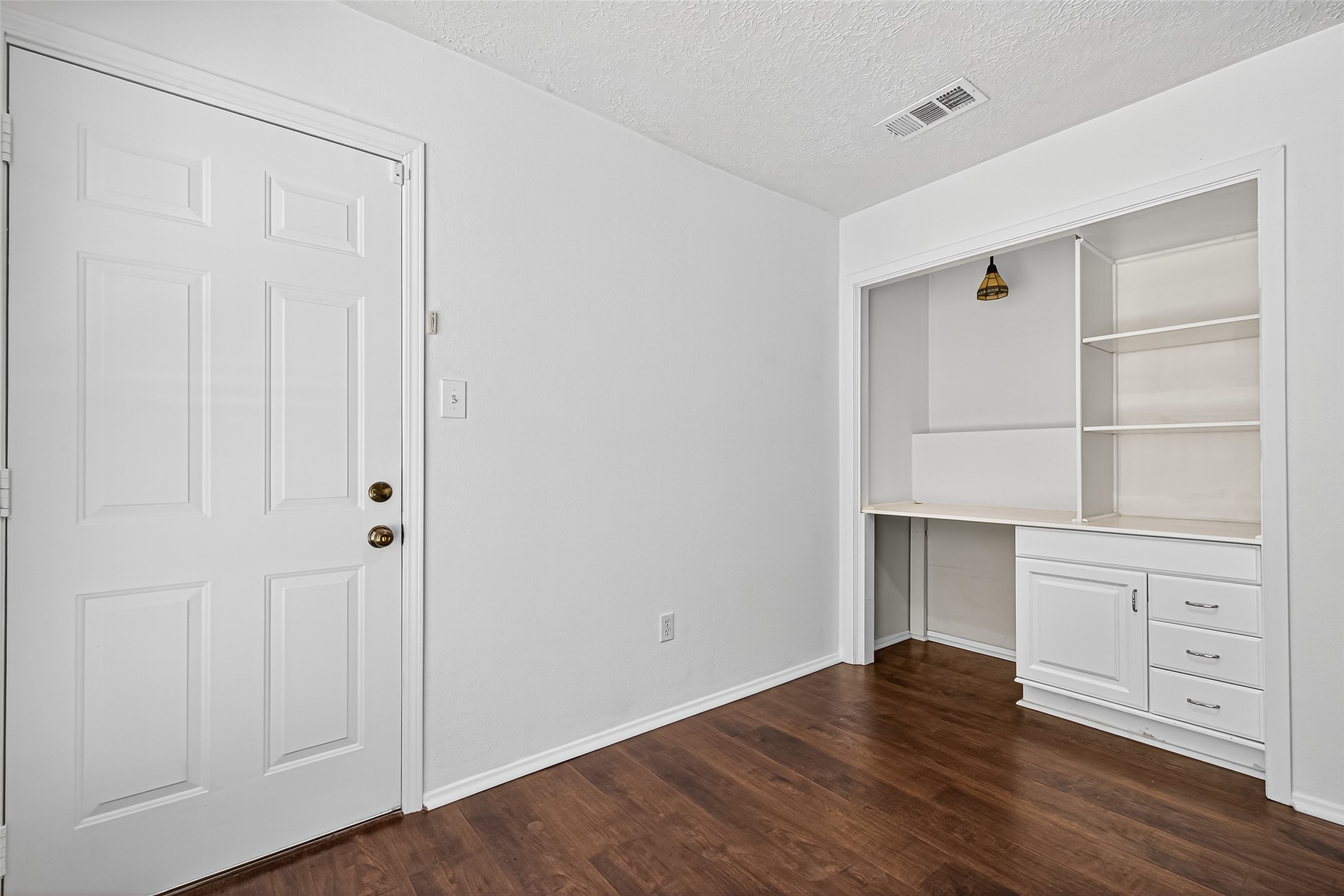 12910 Aste Lane Houston, TX 77065 - Photo 18 of 37 a view of cabinets and wooden floor