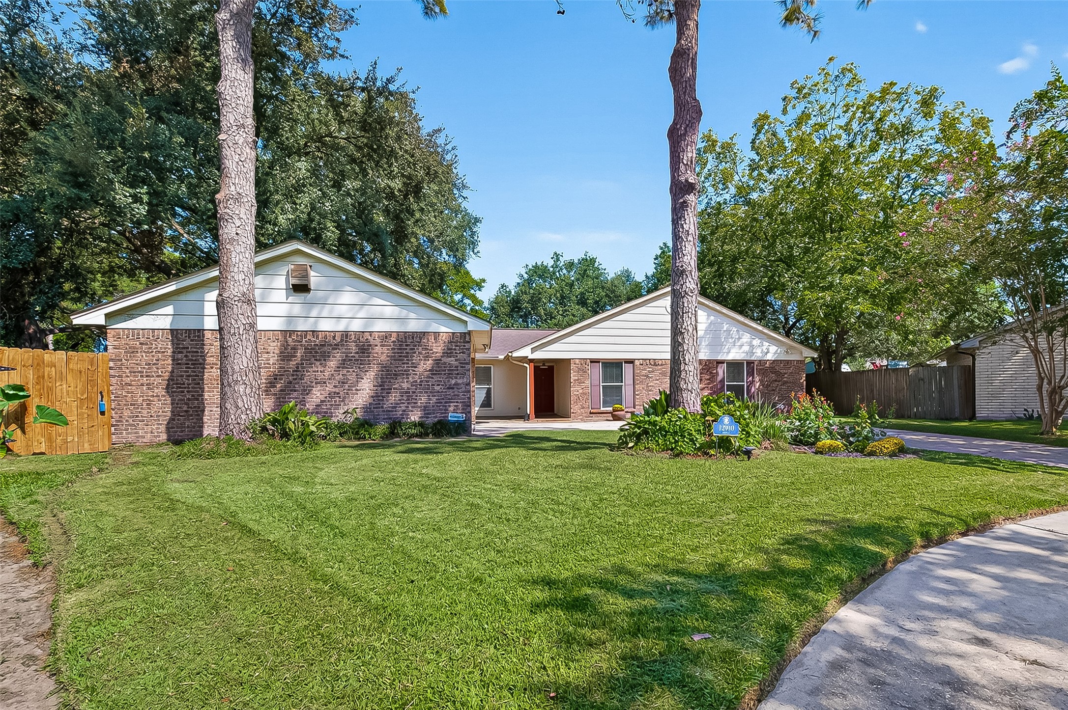 12910 Aste Lane Houston, TX 77065 - Photo 2 of 37 a view of a yard in front of a house with plants and large tree