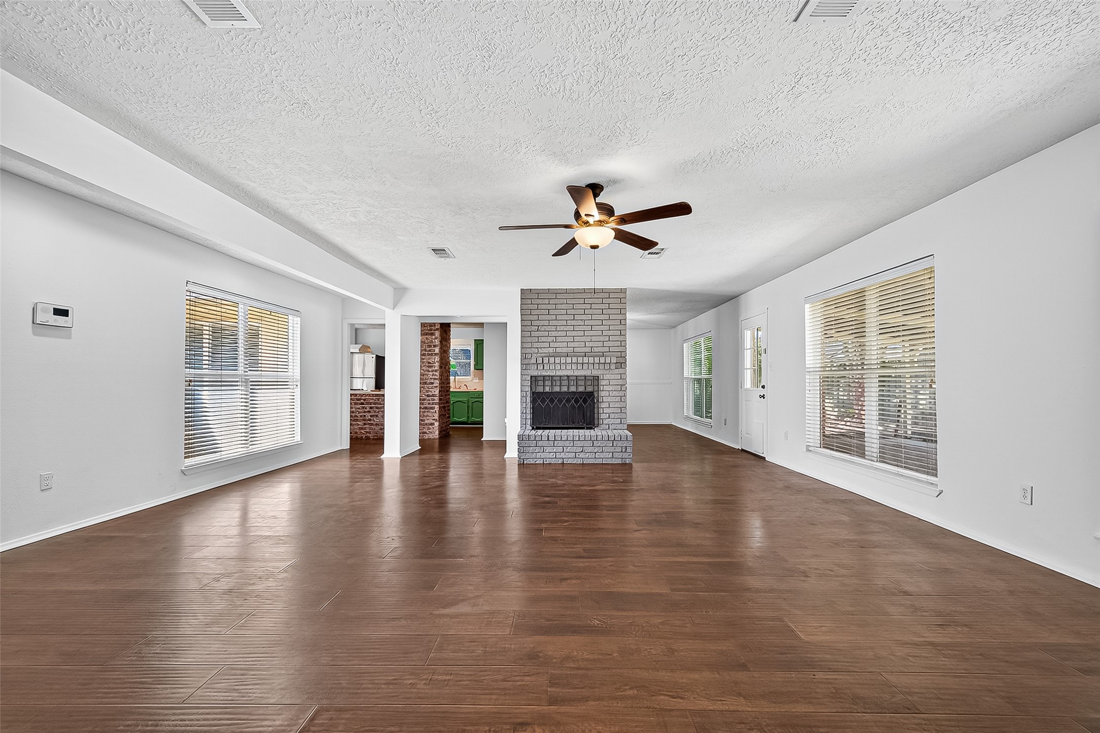 12910 Aste Lane Houston, TX 77065 - Photo 5 of 37 a view of an empty room with wooden floor and a window