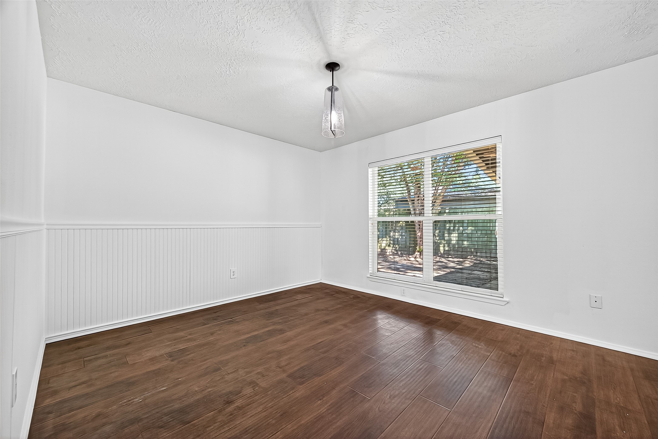 12910 Aste Lane Houston, TX 77065 - Photo 8 of 37 an empty room with wooden floor and windows