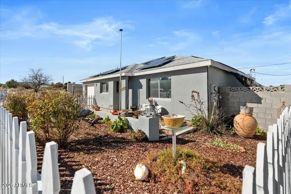 a view of a house with backyard and sitting area
