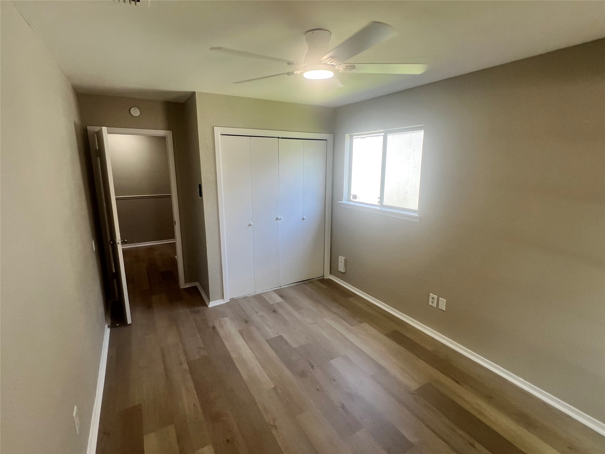 4620 Button Bend Road Austin, TX 78744 - Photo 16 of 22 Hardwood-style flooring and a window create a comfortable and airy personal retreat.